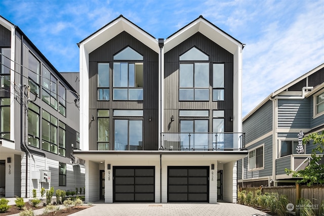 contemporary home featuring a balcony and a garage