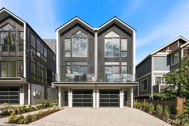 view of front facade featuring a balcony and a garage