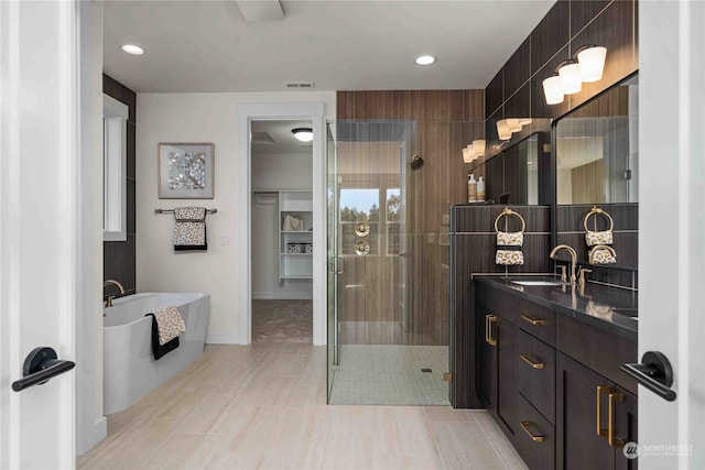 bathroom featuring independent shower and bath, vanity, and tile patterned floors