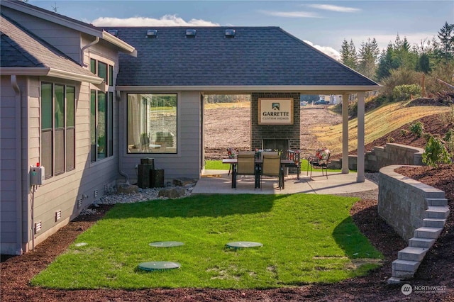 back of house featuring a yard and a patio