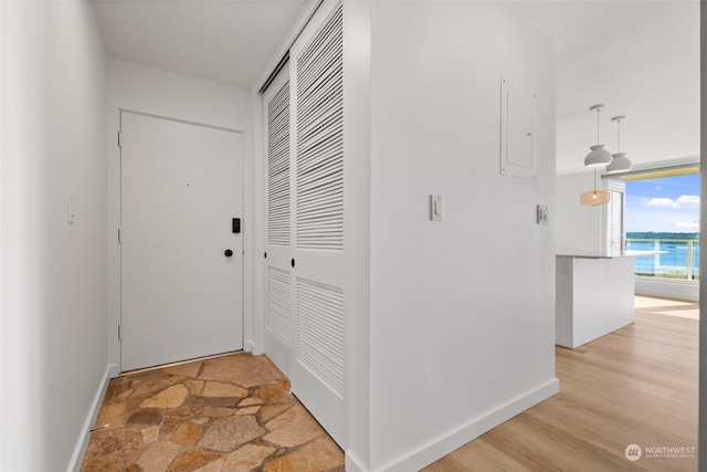 hall featuring wood-type flooring and a water view