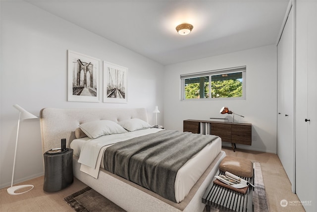 bedroom with light carpet and a closet