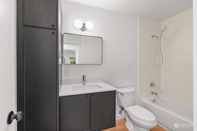 full bathroom featuring wood-type flooring, shower / bathtub combination, vanity, and toilet