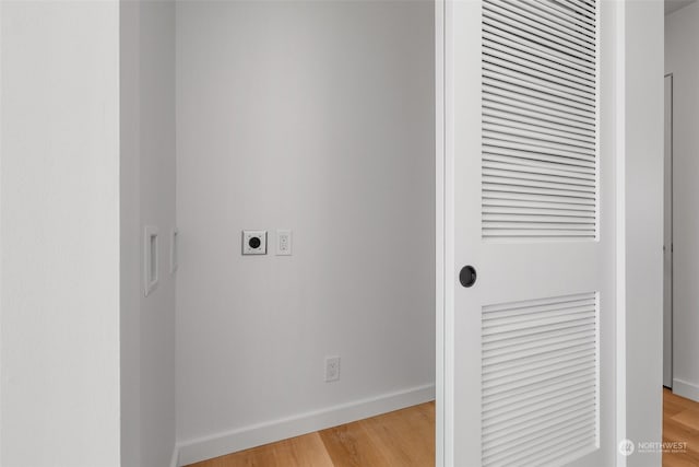 washroom featuring light hardwood / wood-style flooring and hookup for an electric dryer