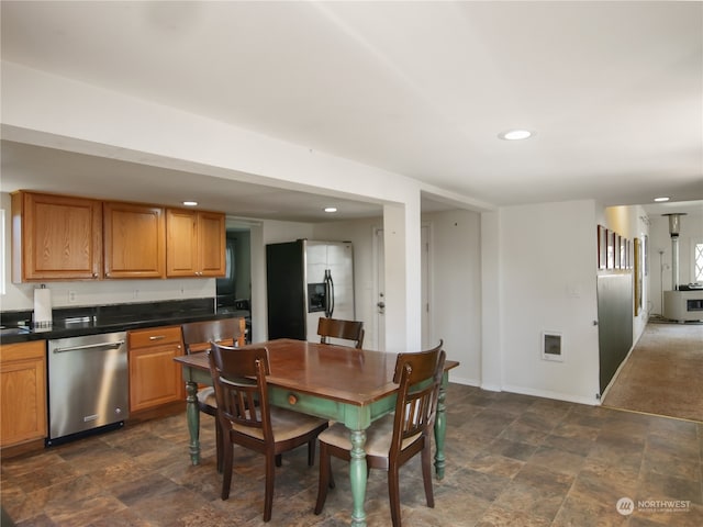 kitchen with dark carpet and stainless steel appliances