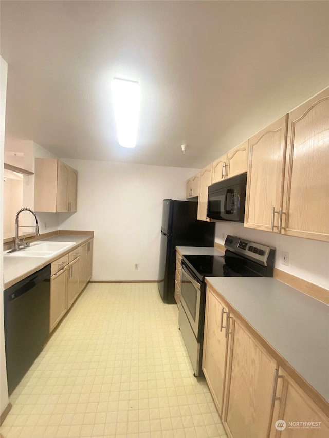 kitchen with light brown cabinetry, sink, and black appliances