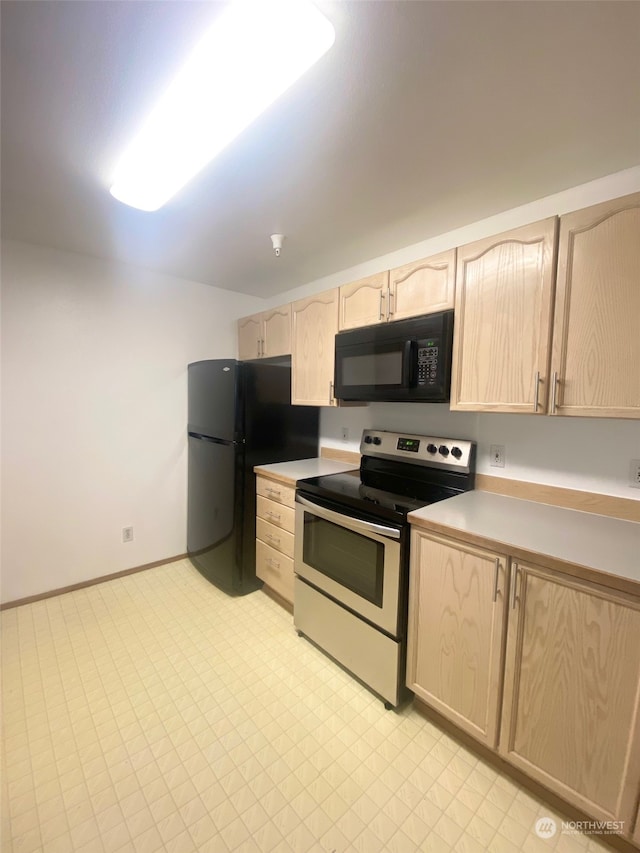 kitchen featuring black appliances and light brown cabinetry