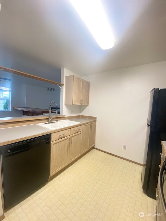 kitchen with light brown cabinets, sink, fridge, stainless steel range oven, and black dishwasher