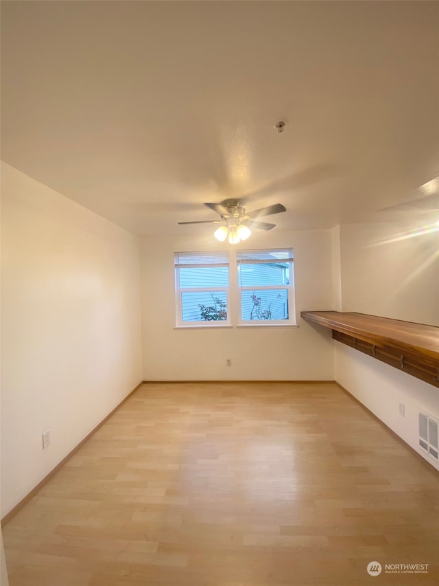 spare room featuring ceiling fan and hardwood / wood-style flooring