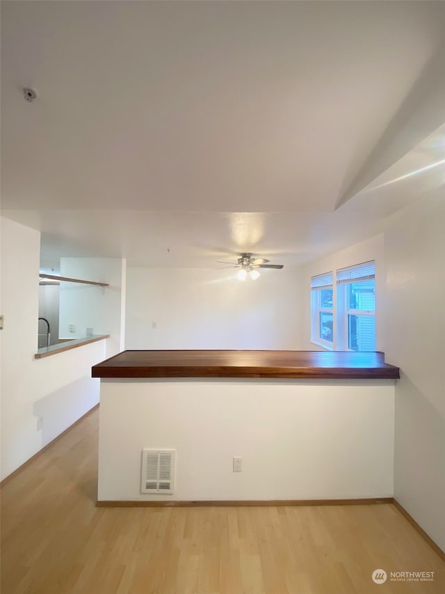 unfurnished room with ceiling fan and hardwood / wood-style flooring