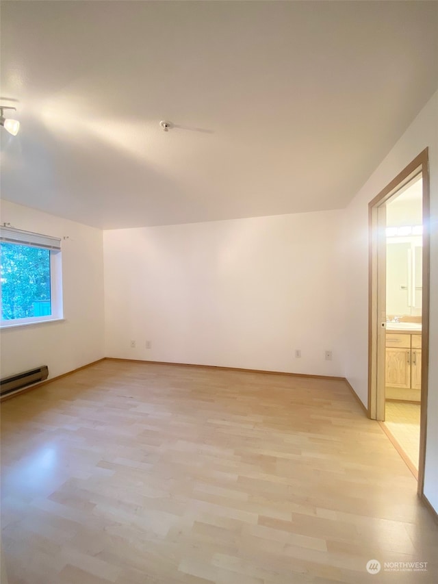 bonus room featuring light hardwood / wood-style floors and baseboard heating