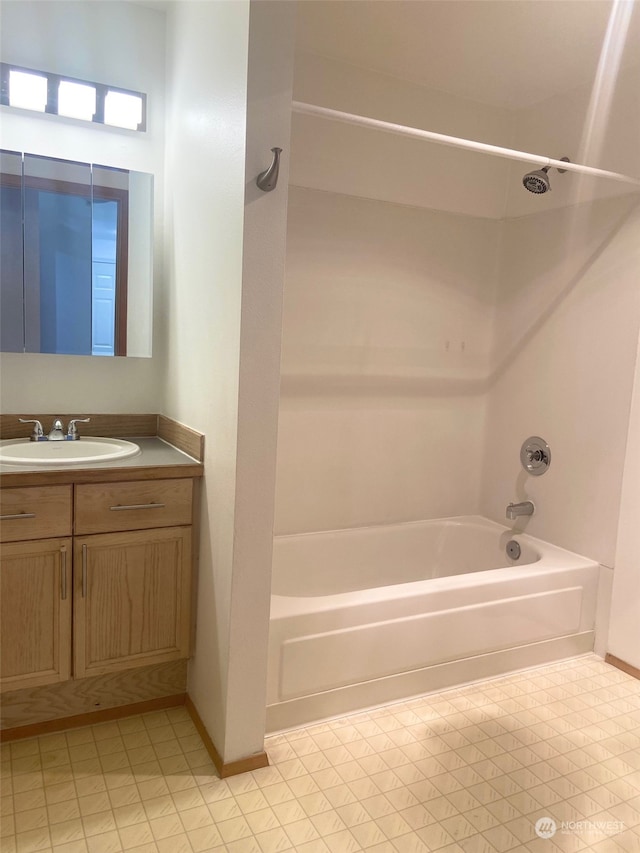 bathroom featuring washtub / shower combination and vanity