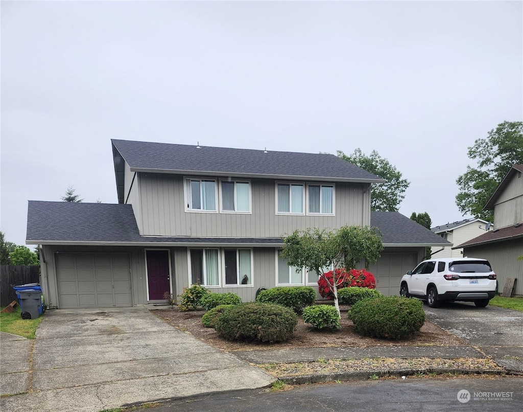 1814 SE 145th Ct, Vancouver, WA 98683 - traditional-style house with roof with shingles, fence, a garage, and concrete driveway