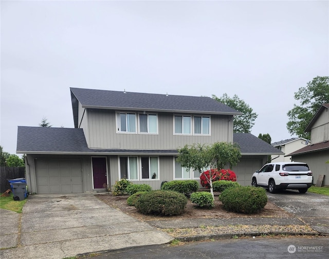 1814 SE 145th Ct, Vancouver, WA 98683 - traditional-style house with roof with shingles, fence, a garage, and concrete driveway