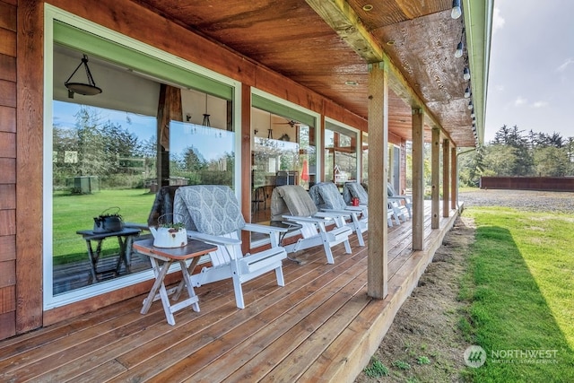 wooden deck featuring a lawn