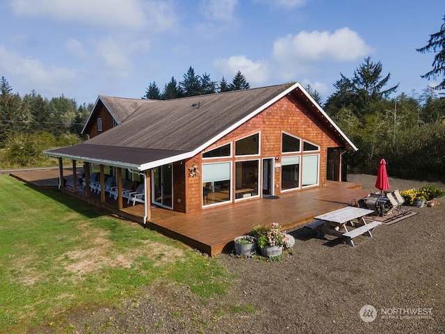 back of house featuring a deck and a yard