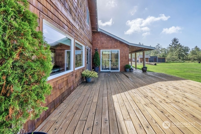 wooden terrace with a lawn