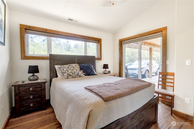 bedroom with access to outside, light hardwood / wood-style flooring, and multiple windows