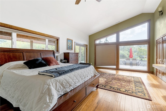 bedroom featuring light wood-type flooring, lofted ceiling, ceiling fan, and access to outside