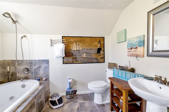 bathroom with tile patterned flooring, sink, lofted ceiling, tiled tub, and toilet