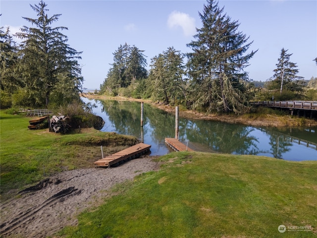 dock area featuring a water view and a yard