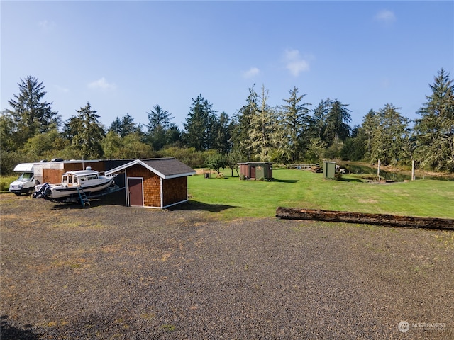 view of front of house featuring a front lawn and a shed