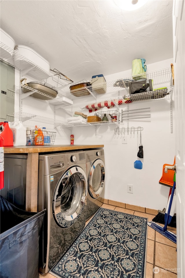 laundry room with tile patterned flooring and separate washer and dryer