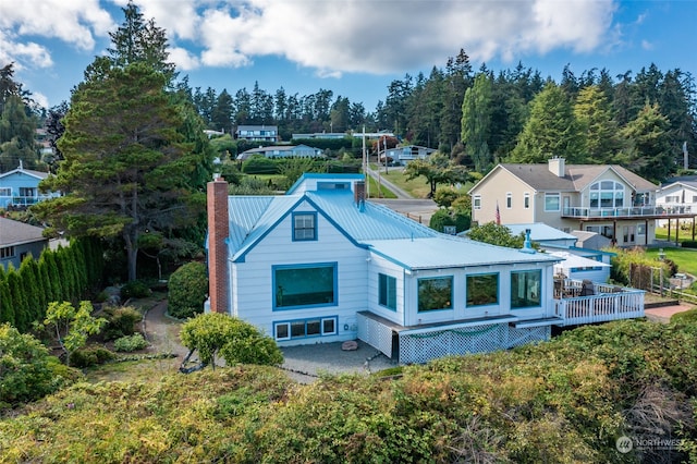 3224 SW Scenic Heights St, Oak Harbor, WA 98277 - back of house with a chimney and metal roof