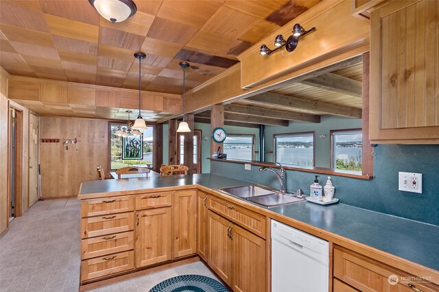 3224 SW Scenic Heights St, Oak Harbor, WA 98277 - kitchen with wooden ceiling with exposed beams, white dishwasher, a sink, pendant lighting, and wood walls