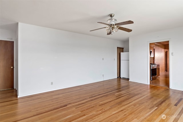 3224 SW Scenic Heights St, Oak Harbor, WA 98277 - unfurnished bedroom with freestanding refrigerator, light wood-type flooring, and ceiling fan
