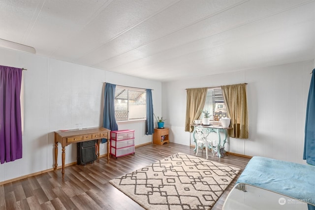 bedroom featuring a textured ceiling and wood-type flooring