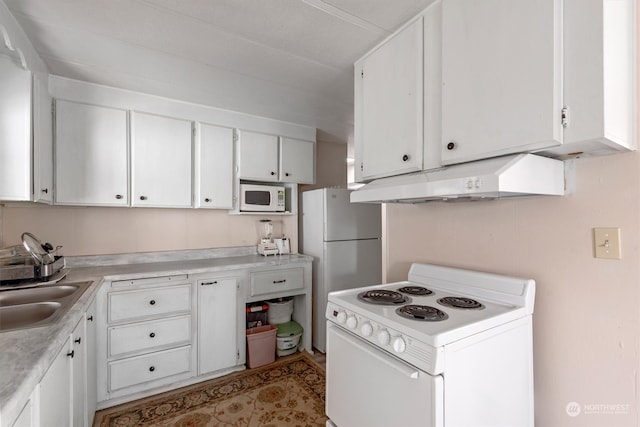 kitchen featuring white appliances, white cabinetry, and sink