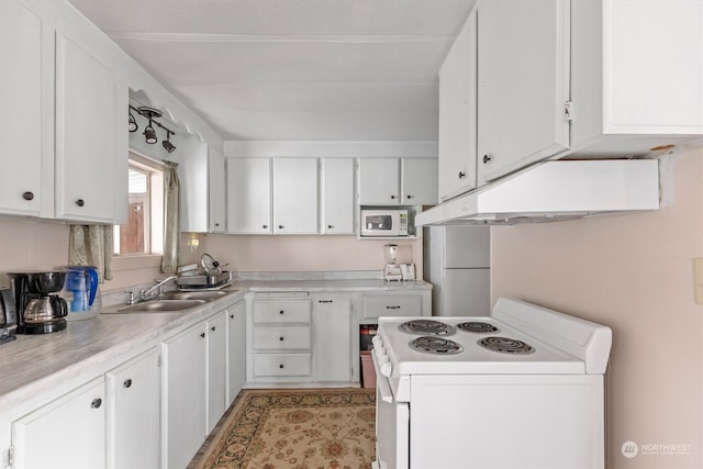 kitchen with white cabinets, sink, and white appliances