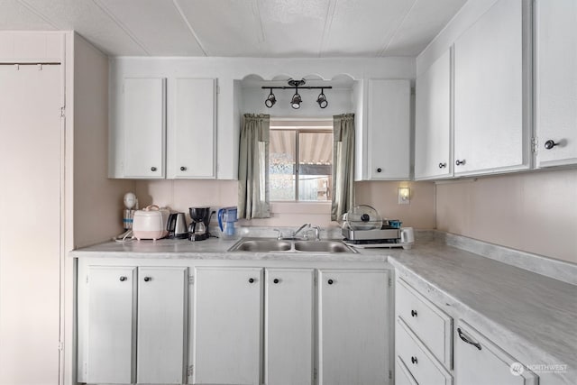 kitchen with sink and white cabinetry