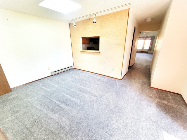 unfurnished living room featuring carpet floors, a baseboard radiator, track lighting, and a textured ceiling