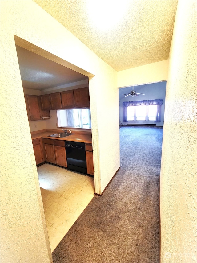 kitchen featuring ceiling fan, dishwasher, light carpet, and a healthy amount of sunlight