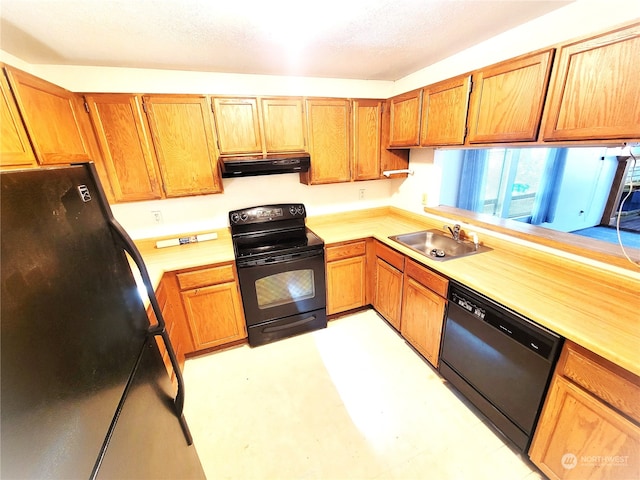 kitchen with a textured ceiling, sink, and black appliances