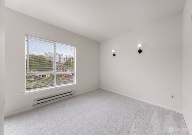 carpeted empty room with a baseboard radiator