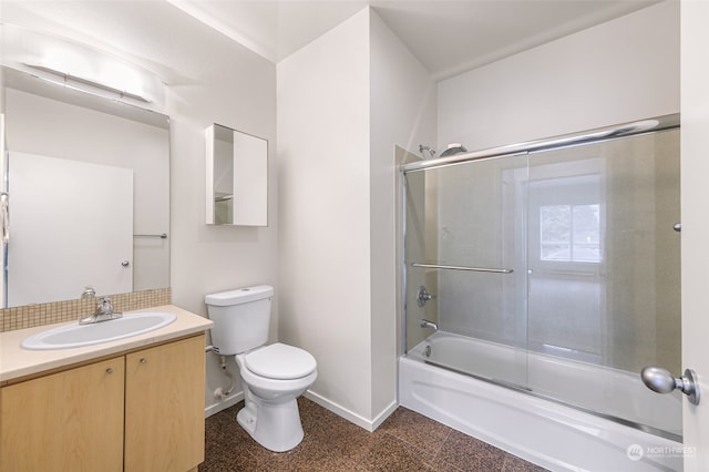 full bathroom featuring toilet, vanity, and bath / shower combo with glass door