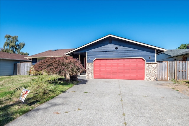 ranch-style house with a front lawn and a garage