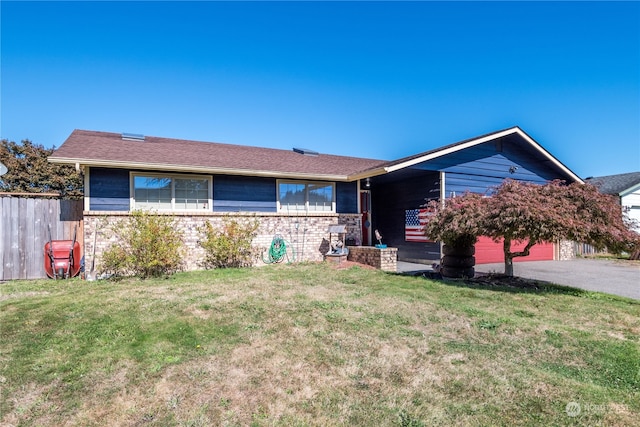 ranch-style house with a front yard and a garage