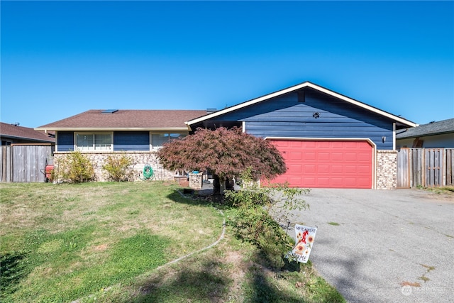 single story home with a front yard and a garage