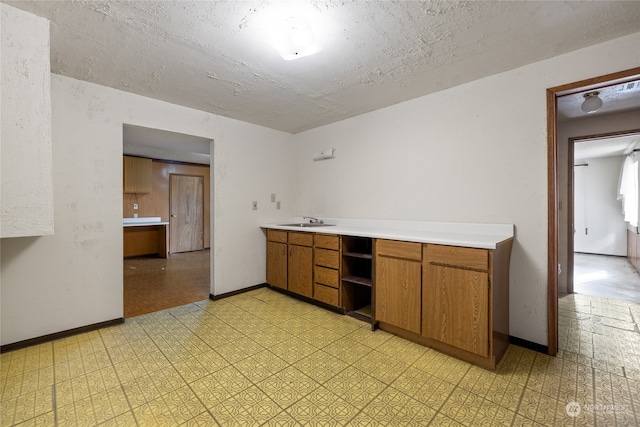 kitchen with a textured ceiling and sink