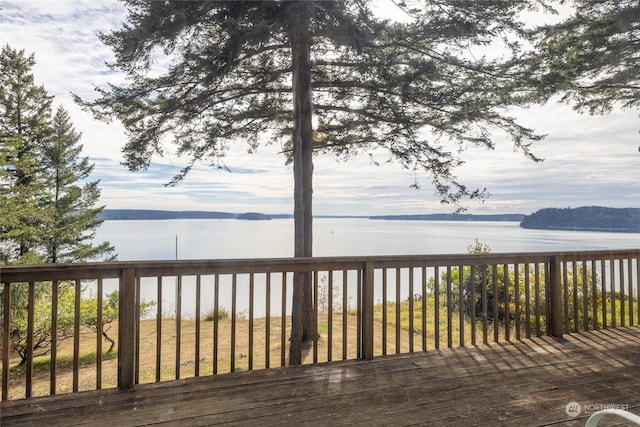 wooden terrace featuring a water view