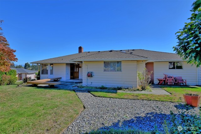 back of house with a lawn