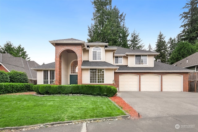 view of front of house featuring a garage and a front yard