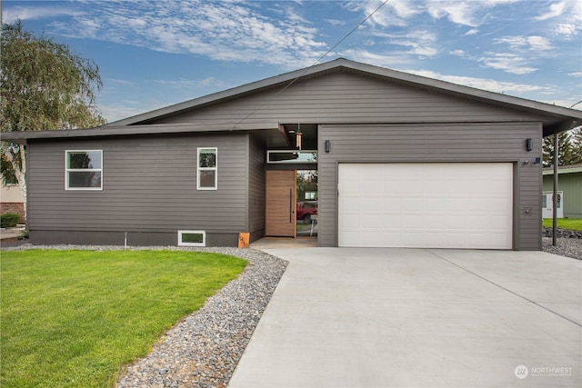 view of front facade with a garage and a front lawn