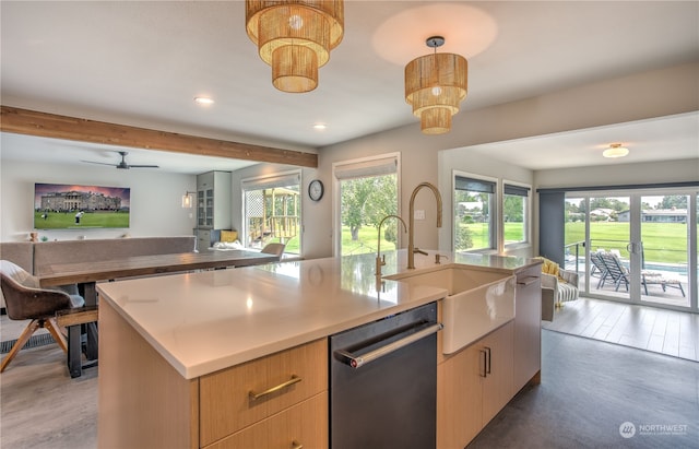 kitchen with pendant lighting, dark hardwood / wood-style floors, ceiling fan with notable chandelier, a center island with sink, and stainless steel dishwasher