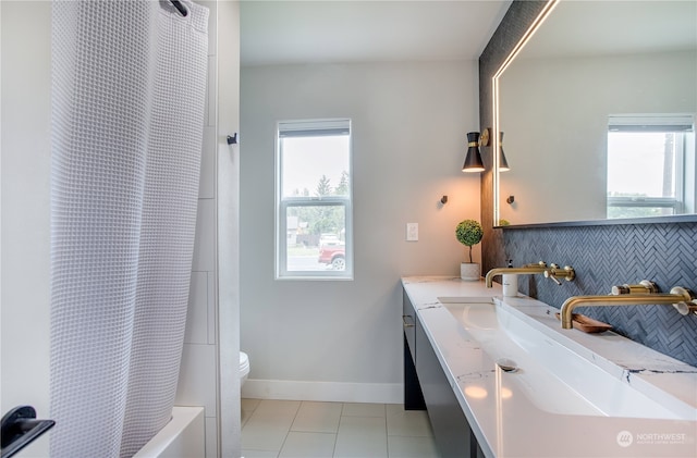 full bathroom with vanity, plenty of natural light, toilet, and tile patterned floors