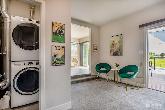 laundry area with stacked washer and dryer and carpet flooring